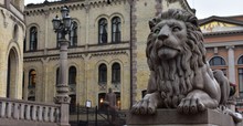 Detail Lion Statue In Front Of Parliament Of Norway Back Ground With Yellow  Building