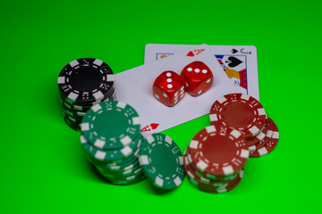 Gambling chips, poker cards on the green poker cloth