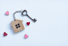 House Key In Heart Shape With Home Keyring On Old Wood Background Decorated With Mini Heart
