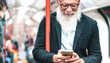 © Mirko Vitali - Hipster bearded man using mobile smart phone in subway train - Trendy adult person checking timetable with smartphone - Happy lifestyle and technology concept without age limits - Indoor neon filter