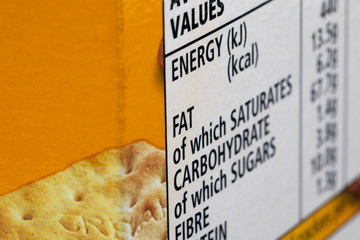 Fat content information displayed on food packaging label with shallow depth of field