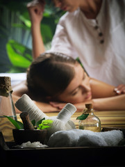 Wall Mural - Portrait of young beautiful woman in spa environment. Focused on objects.