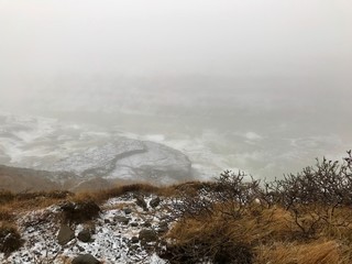 Majestic landscape of Gullfoss (golden waterfall) in Iceland on a cold November day: Outdoor scenery with water flowing down rocks and cliffs in a beautiful wild park in arctic North Europe