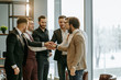 © alfa27 - happy business team, business men in tuxedo joined hands in one, success depends on togetherness and teamwork. isolated in office with panoramic window