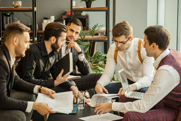 Wall Mural - young caucasian business people in formal wear keeping records on papers, making notes and discuss, isolated in modern boardroom