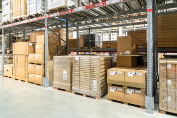 Rows of shelves with boxes in modern warehouse