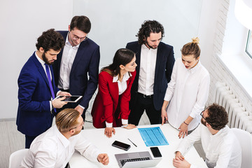 Wall Mural - young business leaders gathered in modern office for discussion, diverse people have successful interaction