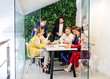 © alfa27 - brainstorm, active discussion of business people in modern office with green wall, everyone in formal wear, have conversation and discussion of business ideas and projects