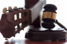 Judge's Gavel And Guitar. Concept Of Entertainment Lawsuit, Music Piracy And Copyright Protection
