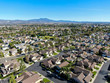 Aerial view of residential suburban packed homes neighborhood during blue sky day in Irvine, Orange County, USA