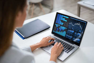 Businesswoman Analyzing Graph On Laptop