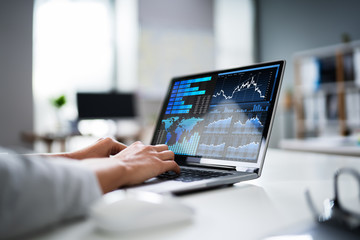 Businesswoman Analyzing Graph On Laptop