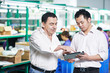 © Kadmy - manager and chinese worker in factory, Managing and cooperation