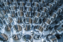A Batch Of Shiny Metal Cnc Aerospace Parts Production - Close-up With Selective Focus For Industrial Background