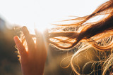Woman touches the lock of hair. Selective focus