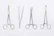 Metal surgical instruments on white background. Flat lay. Top view