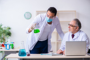 Two chemists working in the lab