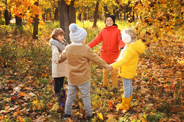 Wall Mural - Cute little children playing in autumn park