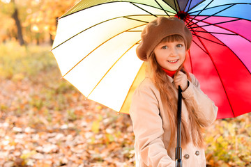 Canvas Print - Cute little girl with umbrella in autumn park