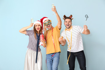 Poster - Drunk friends celebrating New Year against color background