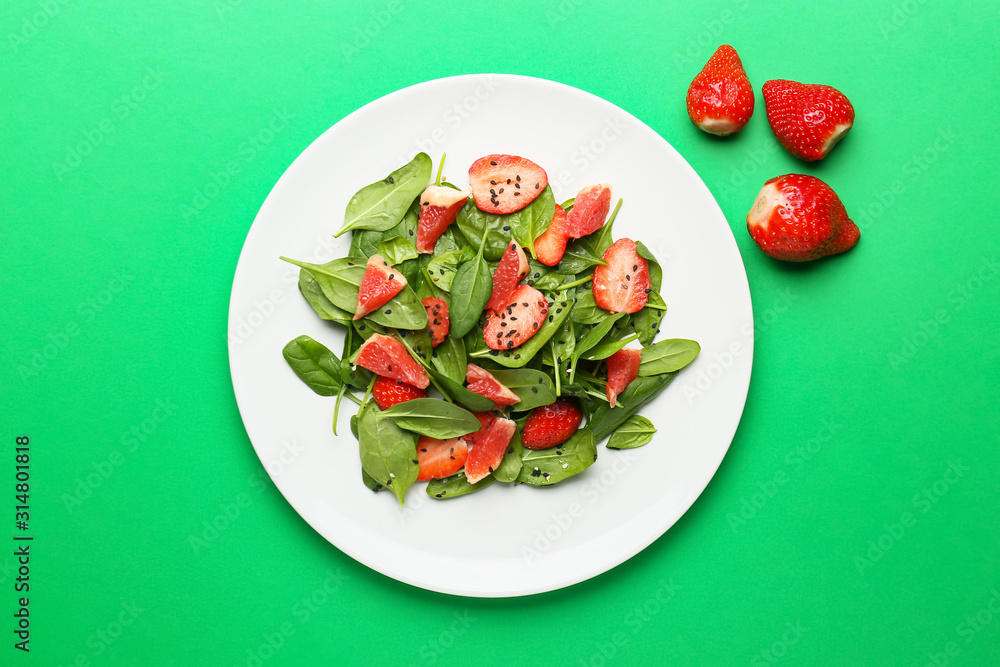 Plate with tasty salad on color background