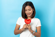 © suriya - Love and valentines day, asian girl holding red heart shape isolated on blue background