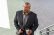© digitalskillet1 - African American businessman drinking coffee on his way to work.