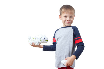 Infatuated child boy playing plastic toy lizard robot with a remote control, isolated on white background. The nano-toy Chameleon spat out a tongue in the child. Modern technology of toys.