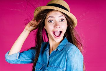 the gorgeous emotion of surprise on the face of the girl in the hat, her eyes are wide, her mouth is