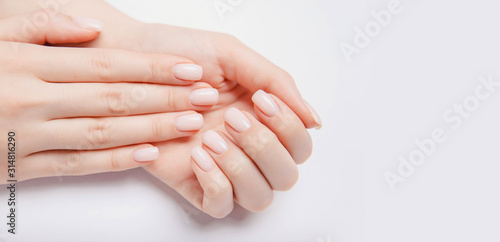 Cuadros en Lienzo Stylish trendy nail young woman hands pink manicure on white background