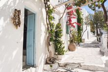 Beautiful Traditional Greek Street With Flowers On Amorgos Island, Greece. 