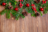 Fototapeta Tęcza - Christmas background with xmas tree and red berries on  wooden background. Merry christmas greeting card, frame, banner. Winter holiday theme. Happy New Year. 