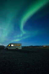 Wall Mural - Aurora Borealis (Northern Lights) above a campervan 