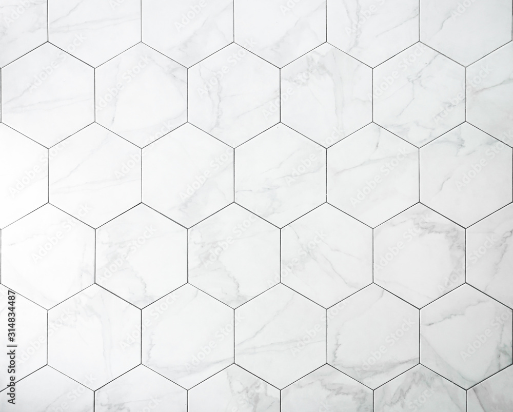 Tiles. A white marble wall with hexagon tiles for texture and background. - obrazy, fototapety, plakaty 