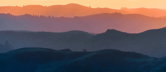 sunset view of hills and valleys, each layer colored differently; santa cruz mountains ; san francis