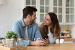 © fizkes - Smiling young man showing funny videos to mixed race woman.