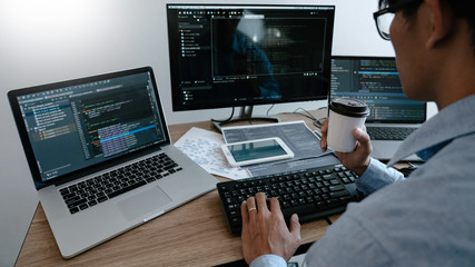 Wall Mural - programmer typing code on desktop computer, developing programming and coding technologies concept.