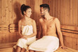 © Alessandro Biascioli - Happy couple relaxing inside sauna spa resort hotel - Romantic young lovers having relaxing day in luxury steam bath salon - Love relationship and wellness health culture lifestyle concept