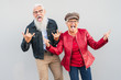 © Alessandro Biascioli - Happy senior couple having fun together outdoor - Retired man and woman celebrating crazy moments - Elderly people lifestyle and love relationship concept