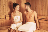 Happy couple relaxing inside sauna spa resort hotel - Romantic young lovers having relaxing day in luxury steam bath salon - Love relationship and wellness health culture lifestyle concept