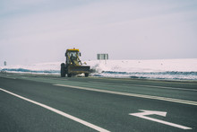 Snowplow Cleans The Highway From Snow On A Frosty Day
