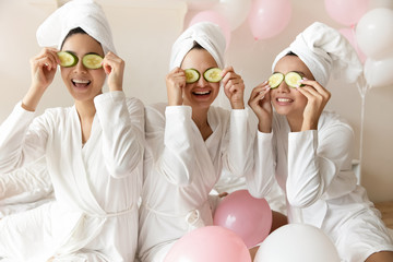 Wall Mural - Overjoyed multiracial girls have fun making beauty procedures at party