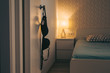 © antgor - Black bra hanging on the hotel door, bedroom on background