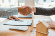 © Nichapa - Customer handshake and sign agreement buying home ,salesman receive money after good deal after successful loan contract
