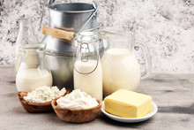 Different  Healthy Dairy Products On Rustic Background With Milk, Cheese, Butter And Cottage