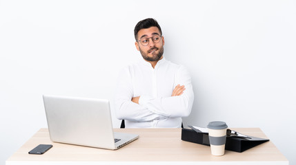 Wall Mural - Young businessman in a workplace with confuse face expression