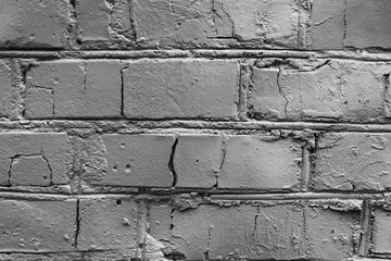 Texture of a brick wall with cracks and scratches which can be used as a background