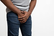 © Prostock-studio - Cropped of black guy holding his groin