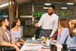 © Prostock-studio - Young boss talking to employees, having board meeting
