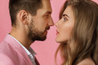 © Rychko Yevhen - couple in love on pink background. man and woman looking at each other. close-up. st valentines day.
